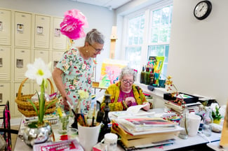 seniors reading by desk