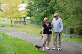 couple walking dog