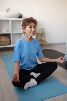 senior-woman-doing-yoga-home